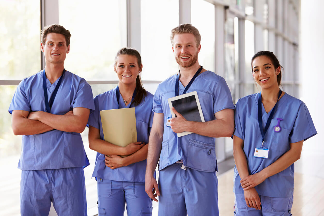 group of 4 medical professionals in scrubs 
